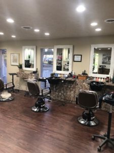 - Results Salon and Spa in Kingsport, TN A clean, well-lit hair salon with three styling chairs, wall mirrors, sinks, and various hair products on marble counters. - Results Salon and Spa in Kingsport, TN