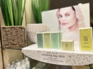- Results Salon and Spa in Kingsport, TN Display of Aveda Tulasāra skincare products next to a plant and a promotional image of a woman, with a sign reading "Wake up to wedding day skin every day. - Results Salon and Spa in Kingsport, TN