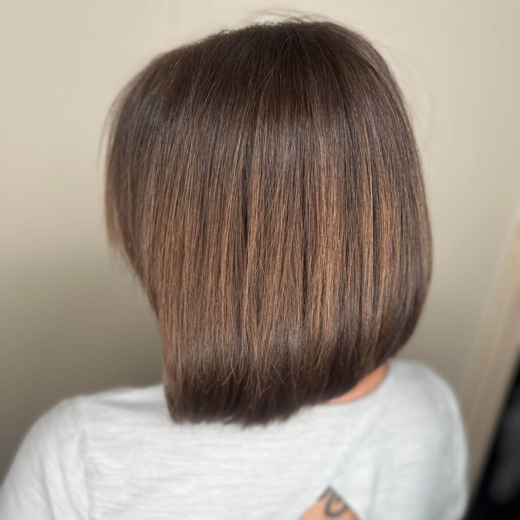 - Results Salon and Spa in Kingsport, TN Person with straight, shoulder-length brown hair seen from behind, wearing a light gray shirt. The hair is smooth and evenly cut. - Results Salon and Spa in Kingsport, TN
